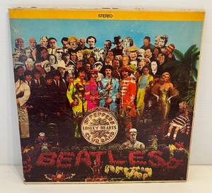 lot 100 image: Original 1967 Sgt. Peppers Lonely Hearts Club Band Album (Album Housing Torn At Top And Scratches Present On Both Sides Of Album)