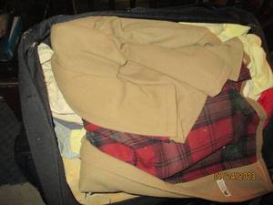 lot 212 image: Suitcase packed with coats and jackets