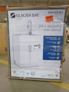 lot 21 image: Glacier Bay All-in-One Stainless Steel 24 in Laundry Sink with Faucet and Storage Cabinet in White - SLIGHT SCRATCH AND DENT, Dowels Broken on Top Brace Board, Cracks in Corner of Cabinet - FOR PARTS OR RESTORE - SOLD AS IS
