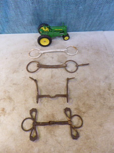 lot 82 image: Vintage Horse Snaffle Bits and Toy John Deere Tractor