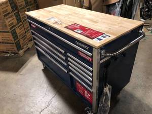 lot 22 image: Husky 52 in. W x 24.5 in. D Standard Duty 10-Drawer Mobile Workbench Tool Chest with Solid Wood Work Top in Gloss Blue  Customer Returns See Pictures