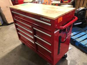 lot 32 image: Husky 42 in. W x 18.1 in. D 8-Drawer Red Mobile Workbench Cabinet with Solid Wood Top   Customer Returns See Pictures