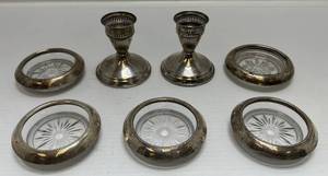 lot 128 image: Group Of Misc. Sterling Items 2 Weighted Candle Holders, 4 Frank M. Whiting Sterling Bottle Coasters, 1 Empire Sterling Bottle Coaster