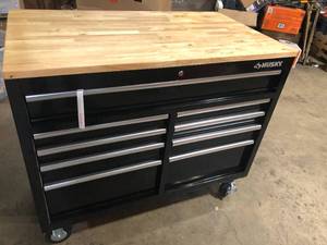 lot 34 image: Husky 46 in.W x 51 in. D Standard Duty 9-Drawer Mobile Workbench with Solid Top Full Length Extension Table in Black  Customer Returns See Pictures