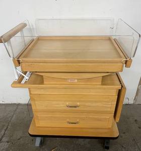 lot 6 image: MSRP $3800 2 Drawer Mobile Wooden Clinical Dropside Hospital Maternity Tilting Bassinet with Dropdown Extension Table, Locking Wheels & More - Good Working Condition
