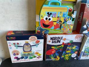 lot 124 image: LOT OF 5 Toys - Sesame Street Elmos Learning Letters, Connect 4 SPIN, battat EDUCATION Penguin Math Balance, MindWare Marble Run and THAMES & KOSMOS Gumball Machine Maker