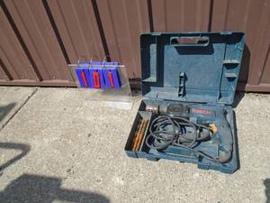 lot 101 image: Bosch rotary drill in case. Used condition. Tested & works. As shown.
