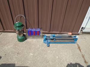 lot 120 image: Green coleman lantern & tile cutter. As shown.