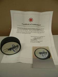 lot 50 image: MINNESOTA WILD Manny Fernandez Signed Puck with COA - GREAT PIECE - SEE PICTURES
