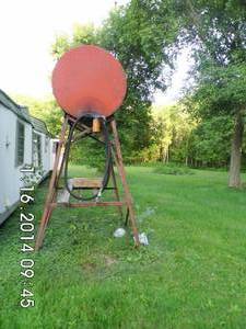 lot 12 image: Vintage 100-gallon metal tank with hose, etc