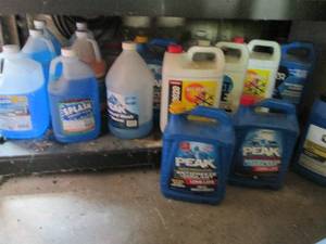 lot 128 image: Multiple 1-gallon jugs of  antifreeze and coolant