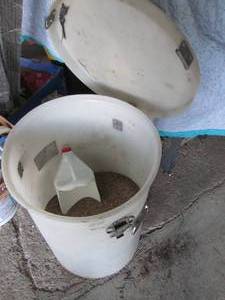 lot 185 image: Huge lidded container half full of traction sand