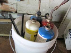 lot 45 image: Bucket containing 1lb propane cylinders