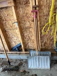 lot 83 image: Contents of Garage Wall Leaf Blowers, Weed Wacker, Rakes & More