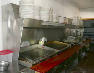 lot 61 image: Stainless table that the grills and fryers are sitting on