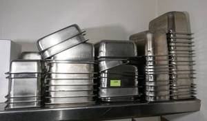 lot 104 image: Large group of stainless pans and tote of covers