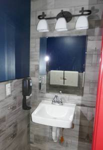 lot 166 image: Mirror, Sink, Light fixture, soap dispenser - womens bathroom