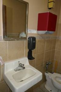 lot 168 image: Sink, mirror, soap and towel dispenser - employee bathroom
