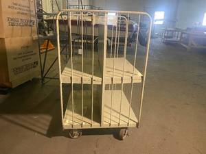 lot 54 image: Double sided 4 Shelf Metal Storage cart, two wheels swivel