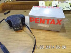 lot 9 image: Brand new (old stock) Pentax camera with accessories and case along with a Vintage Canon camera in a form fitting case