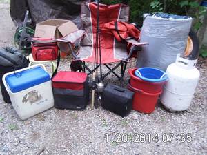lot 19 image: Everything you need to go fishing, camping, or just hanging out in the back yard. Sleeping bag, fishing poles, 30lb propane cylinder, fold up camping table, coolers, fold up chair, nice sleeping mat, and more