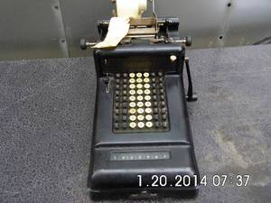 lot 21 image: Vintage Burroughs adding machine with weathered adding machine tape still attached