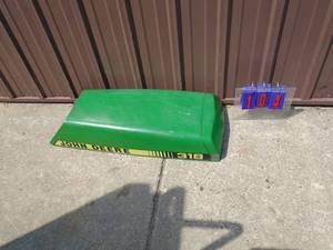 lot 104 image: John Deere 318 fiberglass hood. Very nice shape. As shown.