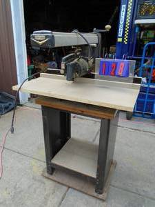 lot 128 image: Craftsman radial arm saw with base & casters. As shown.