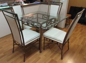 Glass Table top on bronze base with 4 upholstered chairs on metal frame