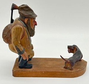 lot 308 image: Wooden Hand Carved Gehst Her Oder Net Man and Dog Figurine