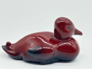 lot 160 image: Royal Doulton Flambe Red Glazed Duck Resting Porcelain Figurine