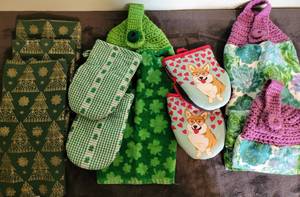 lot 100 image: Kitchen Towels- 4 Green and gold christmas, 2 clover pot holders, 1 clover crochet towel, 2 valentine corgi pot holders, 2 succulent crochet towels