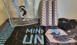 lot 106 image: Minnesota United Gear- 1 Clear tote (shows wear marks from Staduim use) Seat warmer, Gloves, Banner