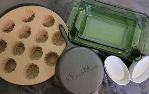 lot 127 image: Bakeware- Green Glass 1 Qt and 2 Qt, 4 small white ramekins, Pioneer Woman small cast iron pan (has some rust on the outside) Pampered Chef flower cupcake pan (Silicone)