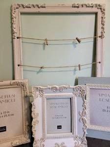 lot 135 image: Vintage Style Picture Frames 3 Frames 1 (2-8x10 and 1- 5x7), Large Frame small wooden clothes pins and twine to hang pitcute from