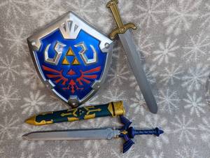 lot 35 image: Zelda sword with shealth and sheild, and additional play sword