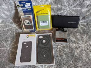 lot 144 image: Google Pixal 3A case in box, blackweb protective Shell for Apple watch 42mm, Ravpower Xtreme Series RP-PB41, and misc items
