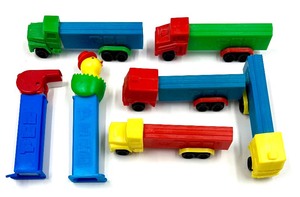 lot 149 image: Vintage PEZ CANDY DISPENSERS - 5 Semi Trucks, Whistle & Chick In Egg