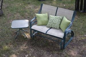 lot 4 image: Outdoor loveseat glider with pillows and side table