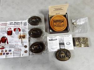 lot 50 image: Hesston National Finals Rodeo Belt Buckles 1975,1979, 1981 (x3), 1-Stick Pin, Set Of Coasters