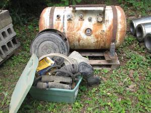 Propane tank and covered tote conta...