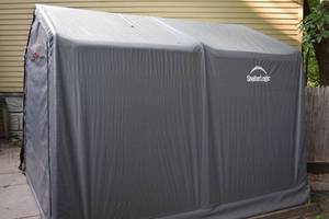 lot 124 image: Shelterlogic Outdoor Storage Tent BRING TOOLS AND HELP TO DISASSEMBLE