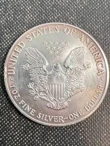 lot 48 image: 1990 AMERICAN SILVER EAGLE 1 TROY OZ .999 FINE SILVER