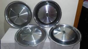 lot 704 image: Olds Oldsmobile hubcaps.