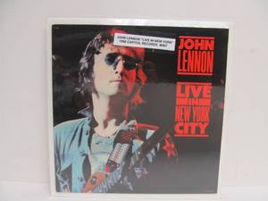 lot 91 image: JOHN LENNON Live in New York City Album Includes Concert Button & Ticket Stub