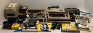 lot 1 image: Vintage Commodore 64 Computers With Floppy Disk Drives, Floopy Disks And More