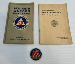 lot 173 image: EXTREMELY RARE Wartime Air Raid Warden Botton WCardstock Advertiseing On Back, Air Raid Warden Manual And Handbook For Canvassers In The Pledge Campaign