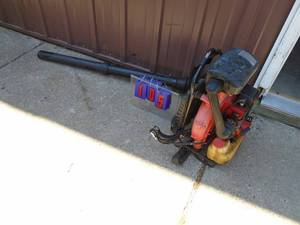 lot 105 image: 2 cycle back pack blower. Used condition. Consignor states it works. As shown.