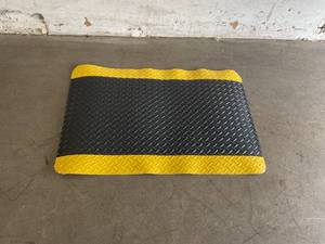 lot 116 image: Durable Corporation 2 x 3 ft. Black with Yellow Border Vinyl Heavy Duty Diamond-DEK Sponge Industrial Anti-Fatigue Floor Mat