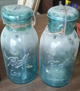 lot 724 image: Antique Ball Jars Blue with bale covers.